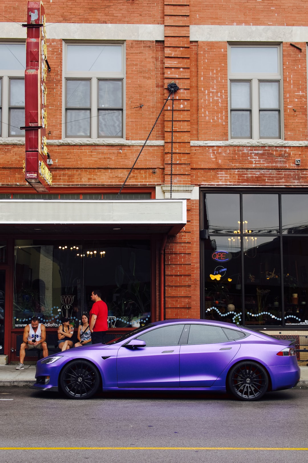 a purple car parked in front of a building