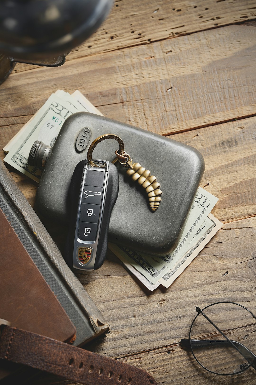 a wallet, keys, and sunglasses on a table