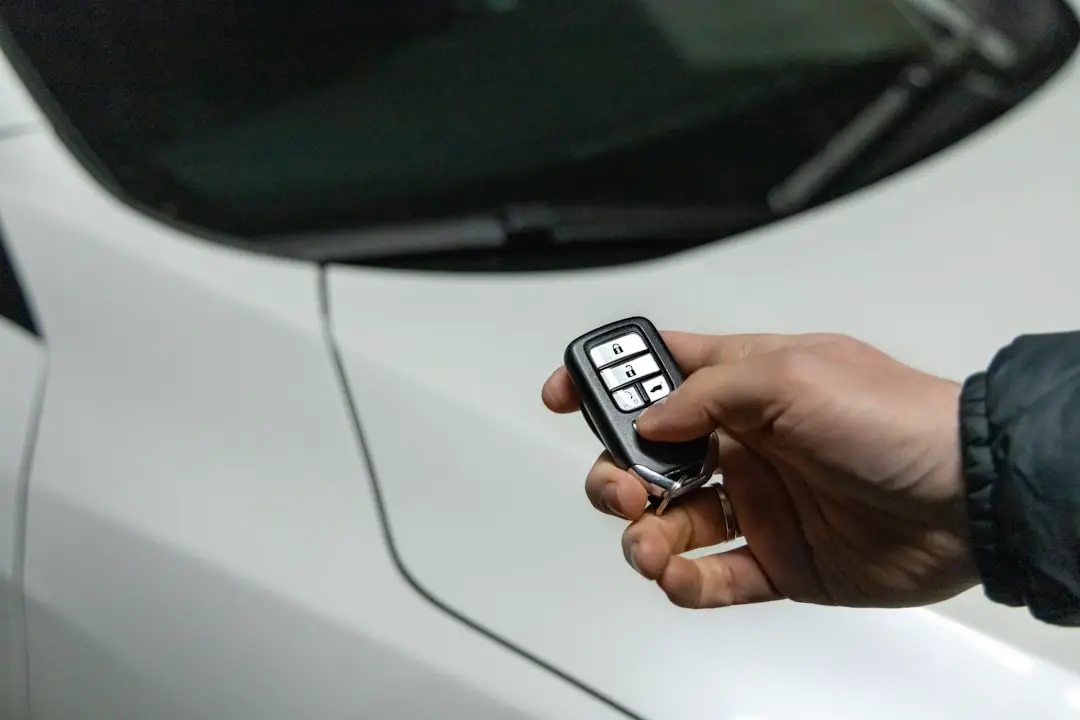Person using a car remote to unlock the vehicle.